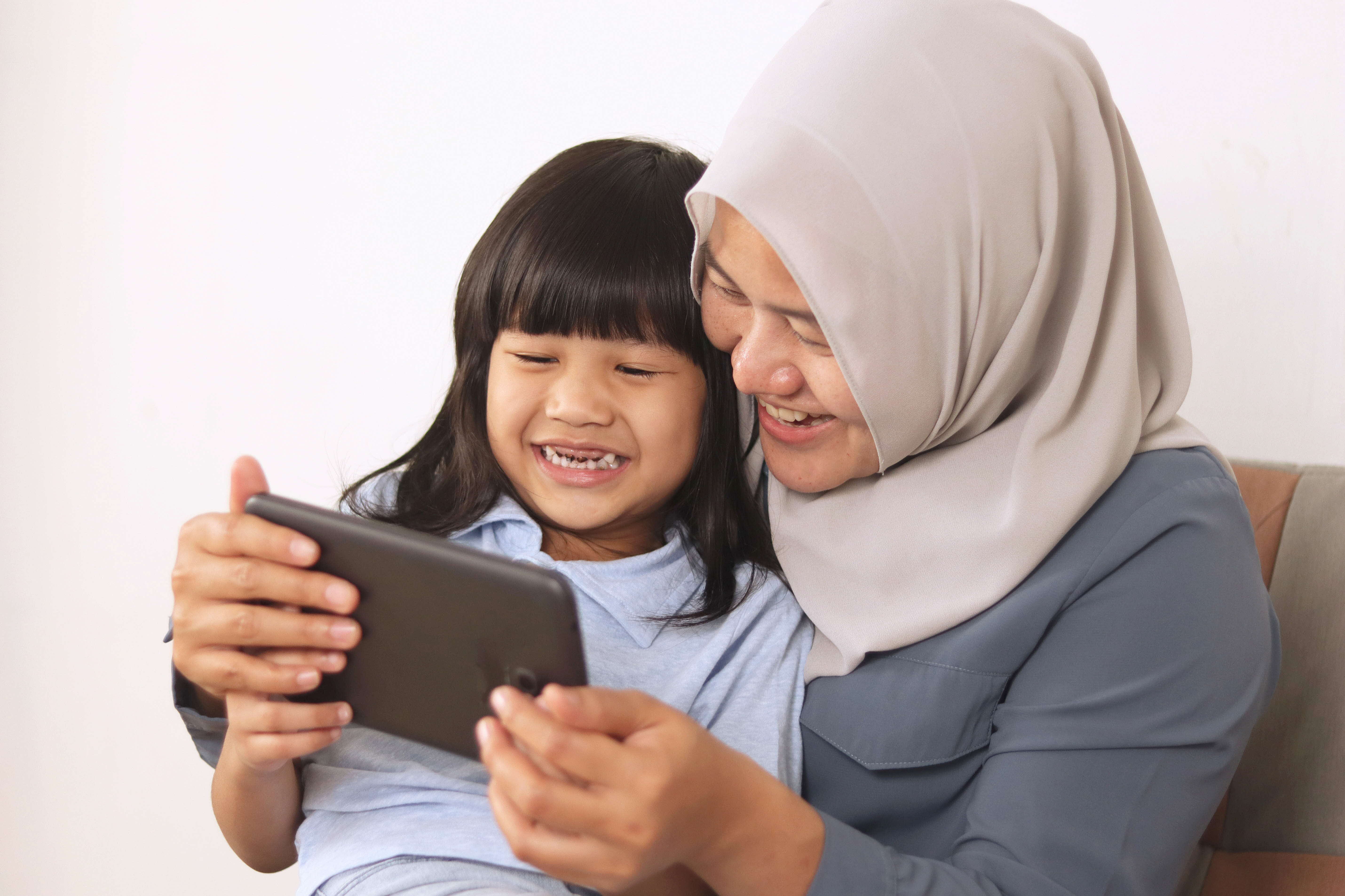 Kid and parent using a tablet