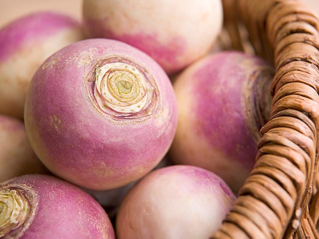 close up of turnips in a basket