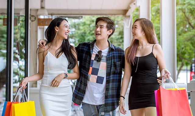 3 friends shopping at a leisurely walking pace.