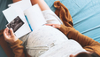 Pregnant mother making notes about her pregnancy journey