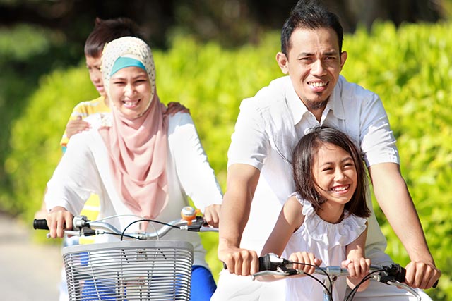 malay family on bicycles exercising
