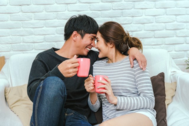 couple holding cups and hugging each other
