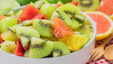 Bowl of freshly cut tropical fruits as a healthy snack to regulate blood sugar levels.