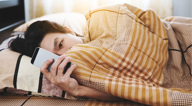 a-man-using-smart-phone-in-the-morning,-checking-message-after-waking-up.jpg