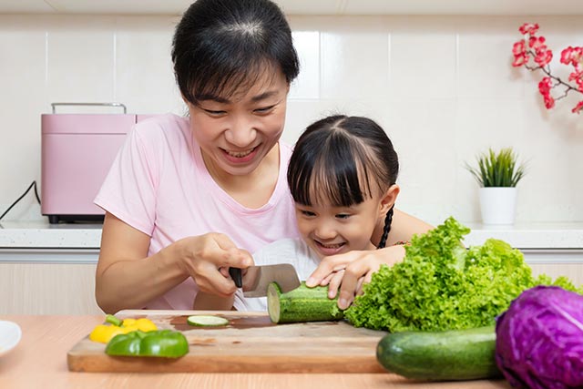 Mother and daughter preparing a salad together