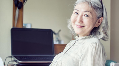 asian-senior-woman-leaned-back-in-her-chair-and-smiling.jpg