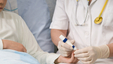 close-up-photo-of-a-nurse-administering-a-finger-prick-test