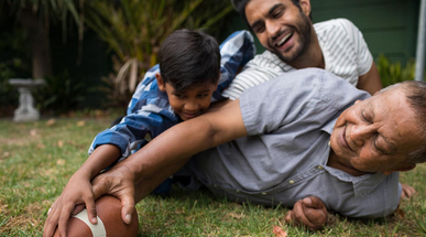 happy-family-playing-american-football-in-yard.jpg