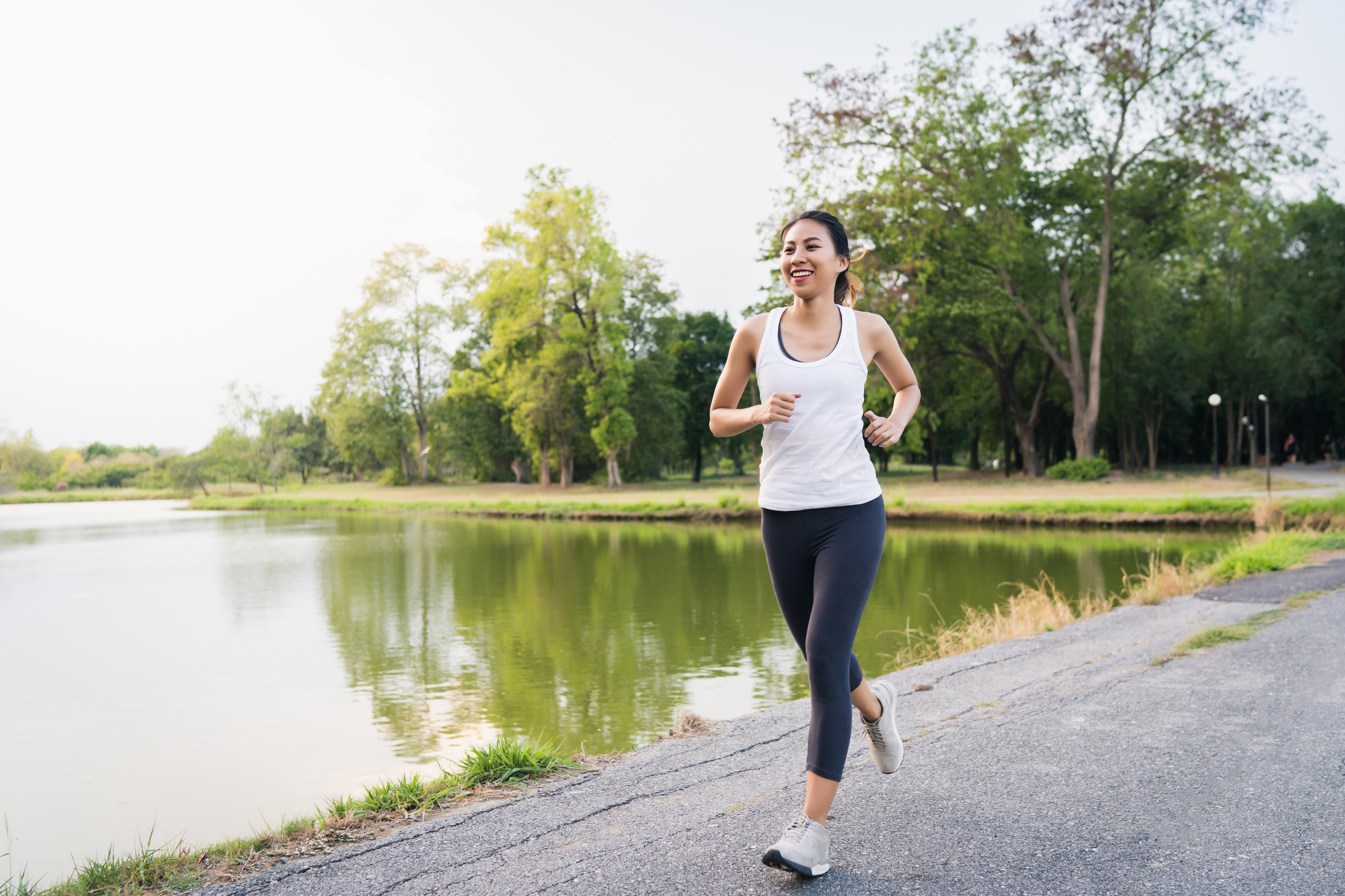 Young woman jogging and engaging in physical activity as part of a sensible weight management strategy.