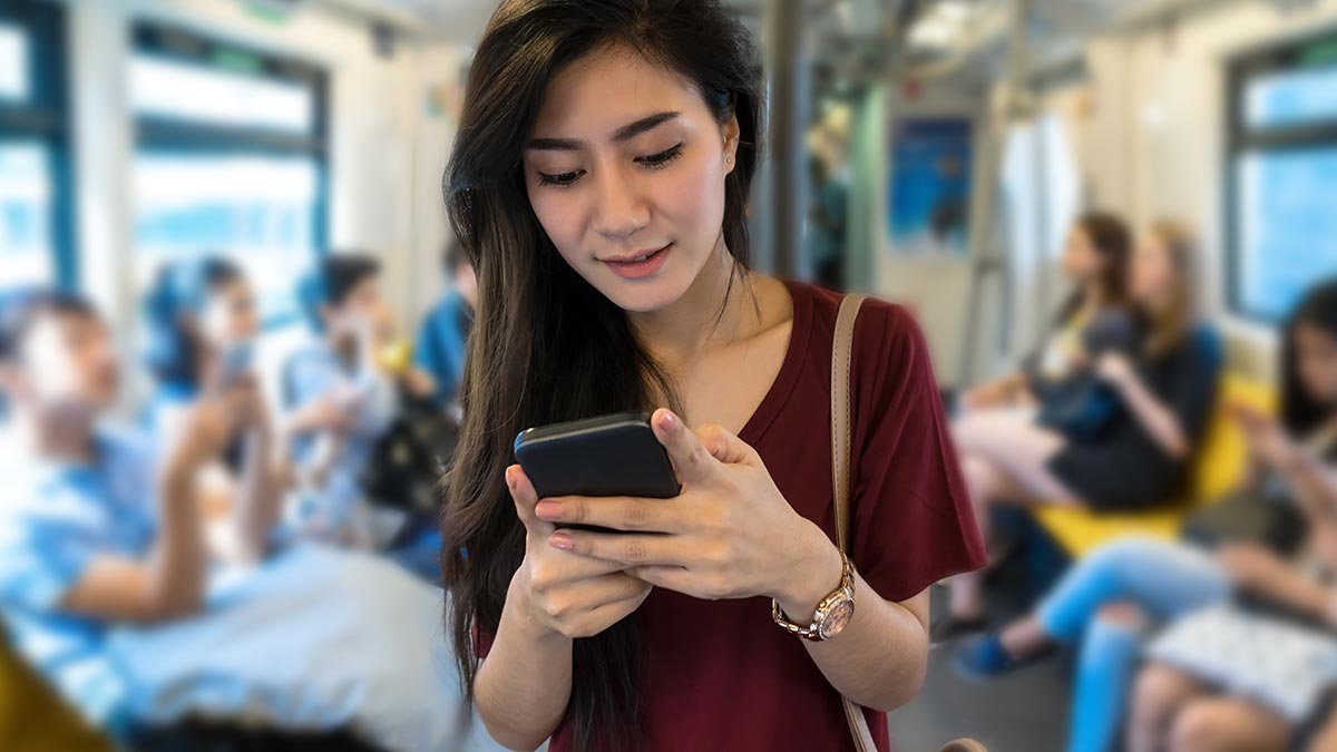 asian-woman-using-mobile-phone-in-the-mrt.jpg