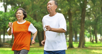 Older adults running in the park to reap the benefits of exercising.