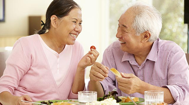 senior-asian-couple-sharing-meal-at-home.jpg