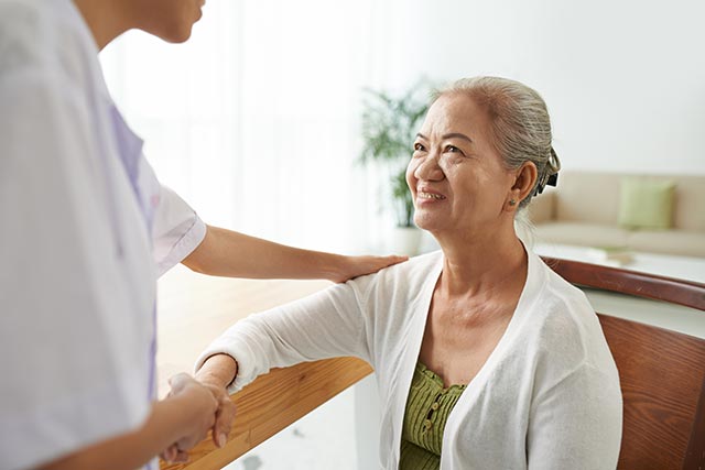 Elderly woman learning more about a breast ultrasound.