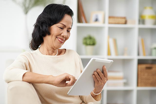 Woman booking a clinical breast examination by a senior consultant online