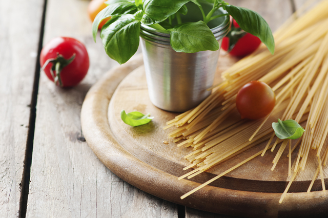Spaghetti with Basil and Cherry Tomatoes on a Wooden Board