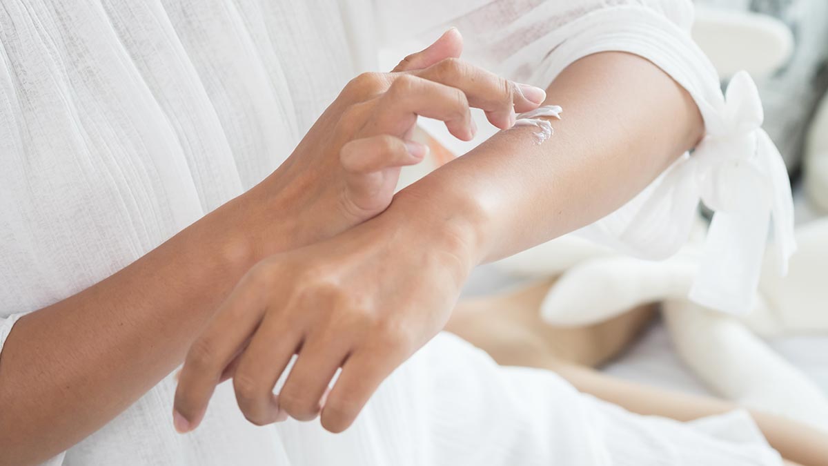 closeup-of-female-hands-applying-cream-on-her-arm.jpg