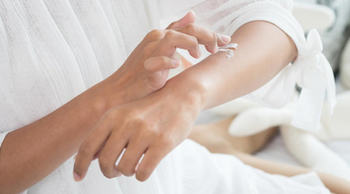 closeup-of-female-hands-applying-cream-on-her-arm.jpg
