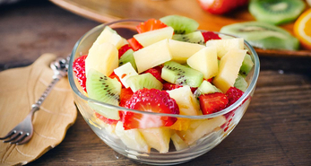 Fruit salad made with banana, strawberries, kiwi and oranges