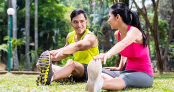 A young couple exercising together to reap the health benefits of a workout together.