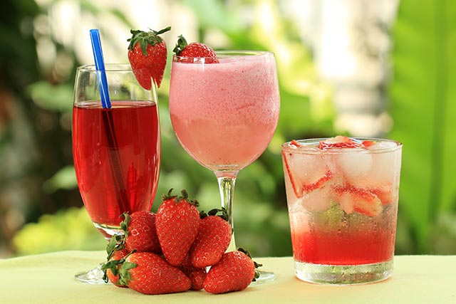 Three different types of drinks made with strawberries, including strawberry cordial, ice blended strawberry juice, and a strawberry and longan mocktail