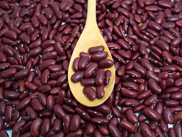 a spoon on top of kidney beans
