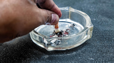 hand-with-a-cigarette-butt-stubbed-out-amidst-ash.jpg