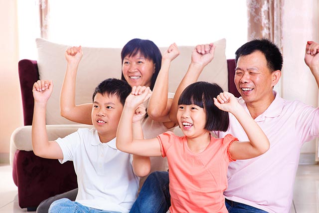A family having fun playing console fitness games together