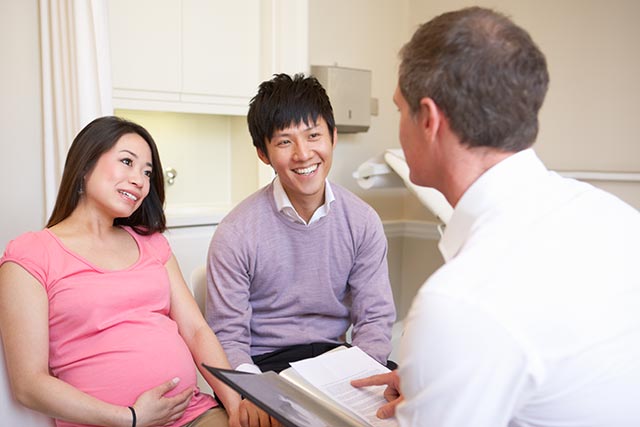 Asian couple visiting the doctors together