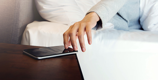 woman-reaching-for-phone-waking-up