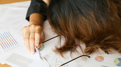 woman-sleeps-on-the-business-report-documents.jpg