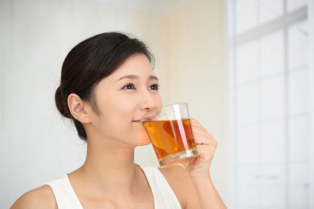 woman enjoying her freshly brewed tea at home
