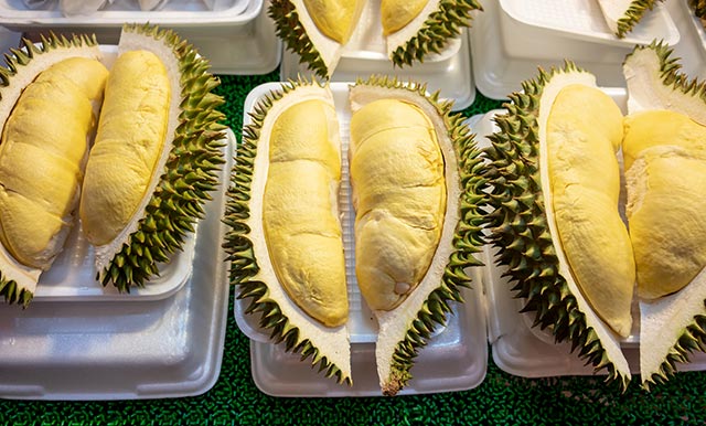 Three opened durian on display
