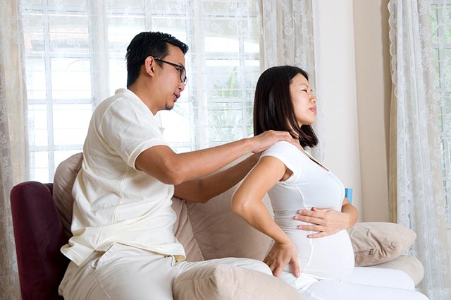 Father-to-be giving his wife a back rub